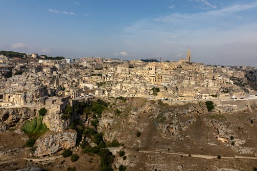 Panoramic view of Sassi di Matera a historic district in the city of Matera, well-known for their ancient cave dwellings from the Belvedere di Murgia Timone,  Basilicata, Italy