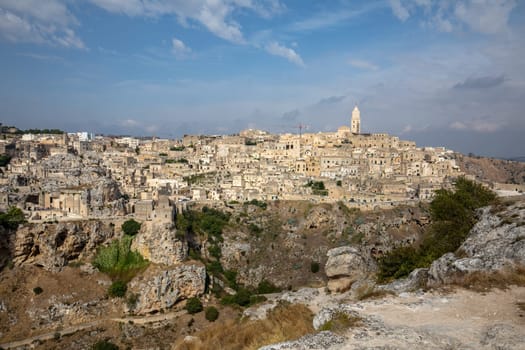 Panoramic view of Sassi di Matera a historic district in the city of Matera, well-known for their ancient cave dwellings from the Belvedere di Murgia Timone,  Basilicata, Italy