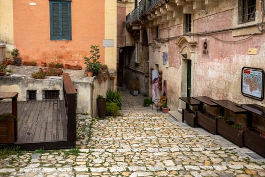 Matera, Italy - September 20, 2019: Typical cobbled stairs in a side street alleyway iin the Sassi di Matera a historic district in the city of Matera. Basilicata. Italy