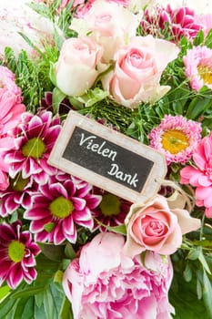 Colorful summer flowers in a bouquet with gift-awepers