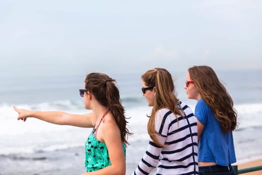 Teenagers girls at beach holidays talk laughter swimming sea ocean waves