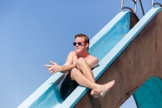 Boy teenager swimming pool summer fun.
