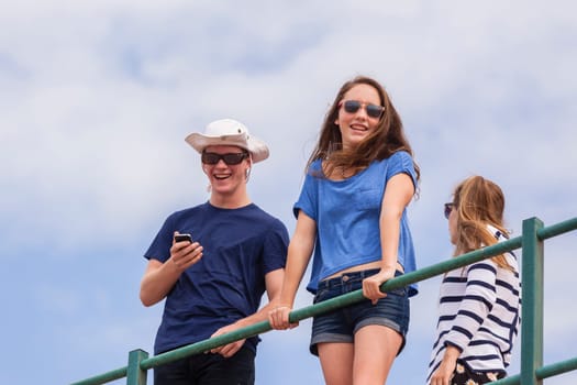 Teenagers at beach holidays talk laughter swimming sea ocean waves