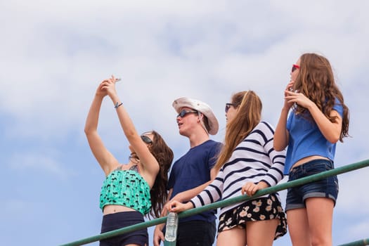 Teenagers at beach holidays talk laughter swimming sea ocean waves
