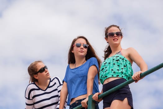 Teenagers girls at beach holidays talk laughter swimming sea ocean waves