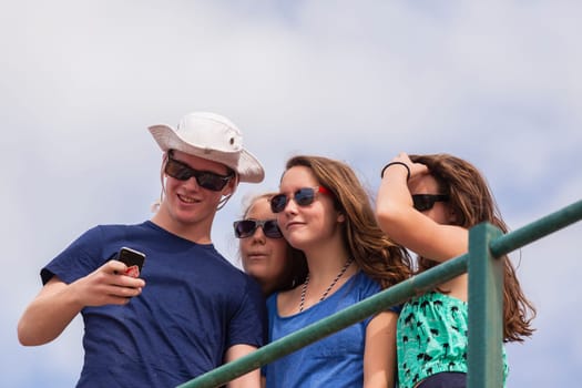 Teenagers at beach holidays talk laughter swimming sea ocean waves