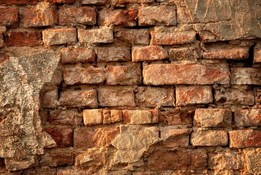 Rustic vintage brick wall in warm sunlight as a texture or background