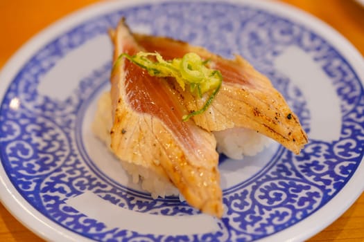 Close-up on Japanese salmon sushi grilled with soya sauce