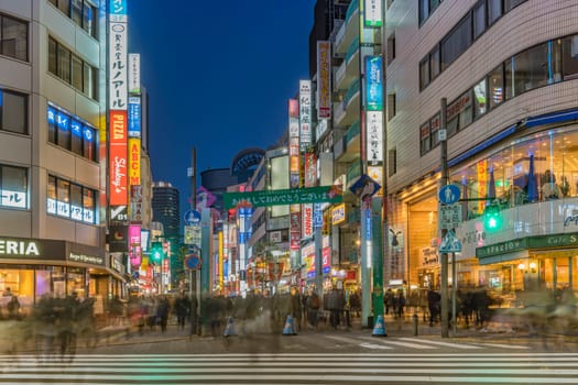 ikebukuro, japan - december 31 2019: Night view of the crowd on the pedestrian crossing of the Sunshine 60 Street leading to the famous otome road decorated for the cebrations of the new year.