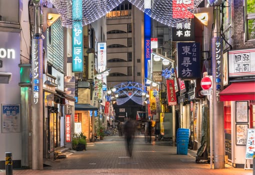 ikebukuro, japan - december 31 2019: Night view of the illuminated entrance gate of the Sunshine Central Street connecting the east exit of Ikebukuro station lines with restaurants and shops leading to the famous otome road decorated for new year.