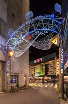 ikebukuro, japan - december 31 2019: Night view of the illuminated entrance gate of the Sunshine Central Street connecting the east exit of Ikebukuro station lines with restaurants and shops leading to the famous otome road decorated for new year.