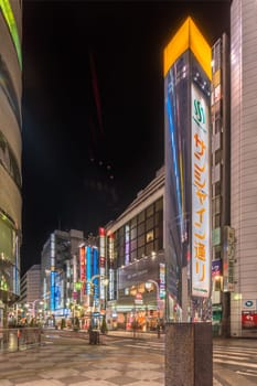 ikebukuro, japan - december 31 2019: Metal pole with the name of the Sunshine Street which connects the east exit of Ikebukuro train station to the otome road during Christmas and New Year at night.