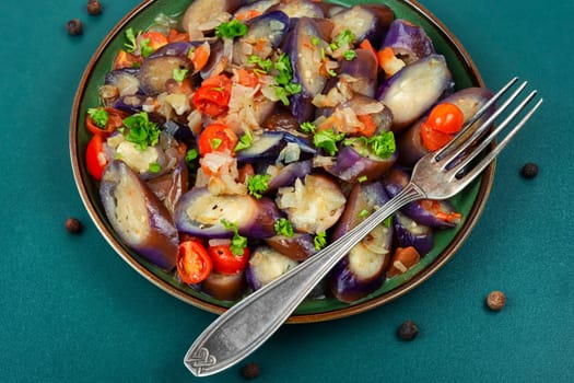 Delicious snack from stew eggplant, tomatoes and garlic with hot spices. Aubergine salad