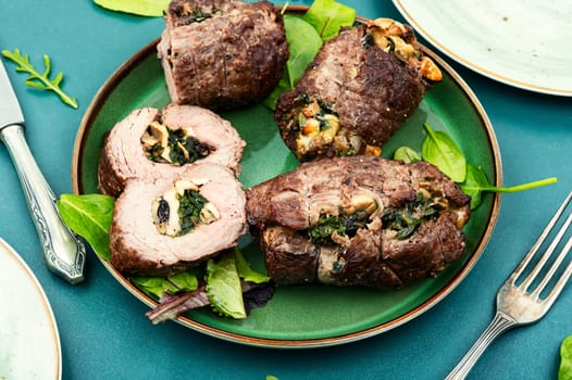 Beef meat rolls stuffed with mushrooms and green. Delicious beef roll filled