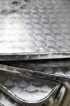Detail of wet metal tables on a cold rainy day in the street