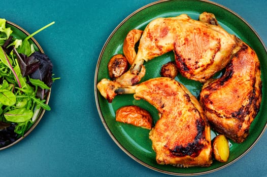 Tasty barbecue chicken drumstick and fresh green salad. Chicken legs quarters