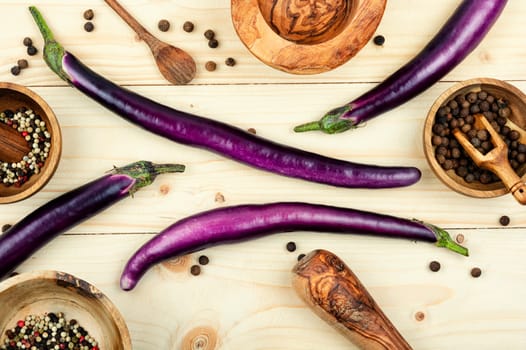Raw colourful vibrant purple eggplants on the kitchen table. Top view