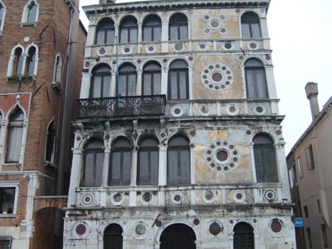 Venice, Italy, July 22, 2007. Venetian streets with graceful building facades. Grand Canal. Along the canal are Gothic and Renaissance palaces. Sights of Italy. Tourism business
