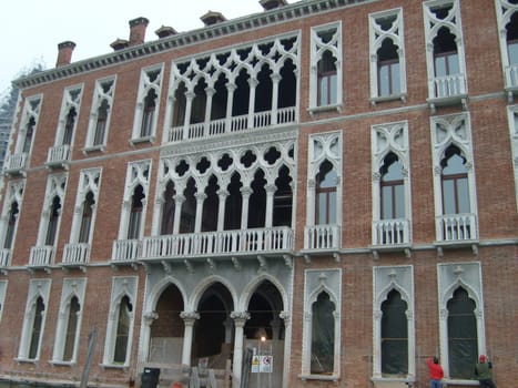 Venice, Italy, July 22, 2007. Venetian streets with graceful building facades. Grand Canal. Along the canal are Gothic and Renaissance palaces. Sights of Italy. Tourism business