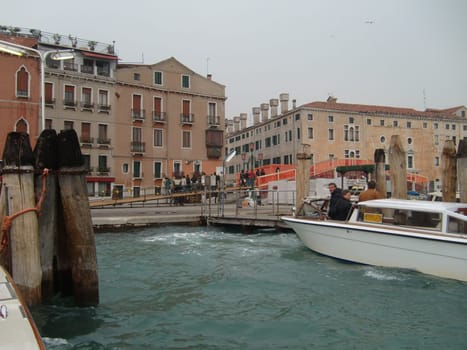 Venice, Italy, July 22, 2007. Venetian streets with graceful building facades. Grand Canal. Along the canal are Gothic and Renaissance palaces. Sights of Italy. Tourism business