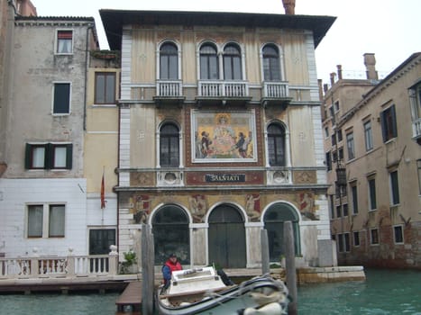Venice, Italy, July 22, 2007. Venetian streets with graceful building facades. Grand Canal. Along the canal are Gothic and Renaissance palaces. Sights of Italy. Tourism business