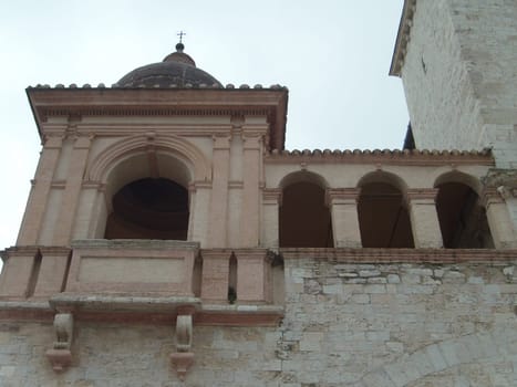 Assisi, Italy, December 1, 2007 Old buildings near the Church of San Francesco in Assisi. The main temple of the Franciscan order in Umbria. Stairs and walls in white stone. Tourist attraction.