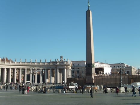 Vatican, Rome, Italy, December 10, 2007, Tuscan order semicircular columns frame St. Peter's Square. Egyptian obelisk from Heliopolis, brought to Rome by Emperor Caligula.