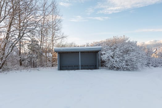 Snow covered lonely bus stop in countryside