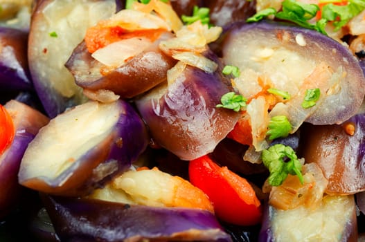 Warm purple eggplant, tomato and garlic salad. Salad of baked vegetables. Copy space for text