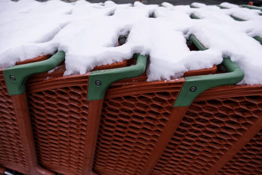 Detail of shopping carts in a supermarket on a winter and snowy day