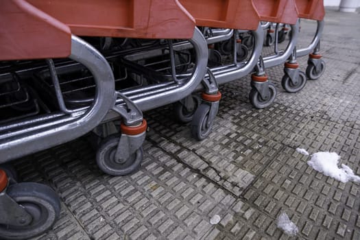 Detail of shopping carts in a supermarket on a winter and snowy day