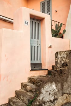 Procida island with colorful houses in small town street