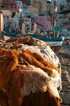 Pretty fishing village, colourful fishermen's houses, and fishing nets, Marina Corricella Procida Island, Bay of Naples, Italy.