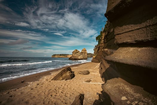 The black Ciraccio beach with the rock formations shaped by the wind on the northwest coast of the island of Procida in the Gulf of Naples