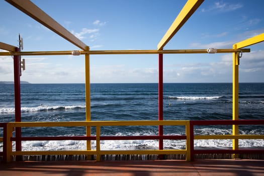 Cozy terrace on the beach, idyllic view of the seashore. Tropical summer vacation concept.