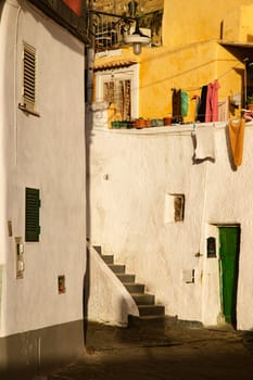 Procida island with colorful houses in small town street
