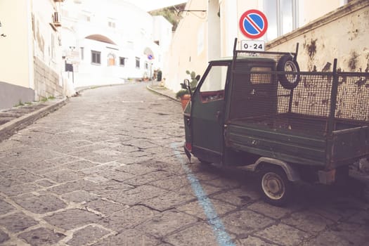 Procida island with colorful houses in small town street