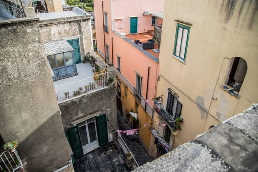 Procida island with colorful houses in small town street