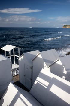 Traditional white wooden beach huts on the beach of Ciraccio, Procida island, Italy
