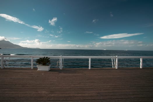 Cozy terrace on the beach, idyllic view of the seashore. Tropical summer vacation concept.