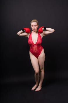 A beautiful, attractive, seductive girl with blonde hair in a studio.