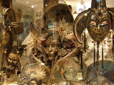 Venice, Italy, September 24, 2020. Venetian masks in a shop window, side view. Beautiful graceful bright carnival masks.