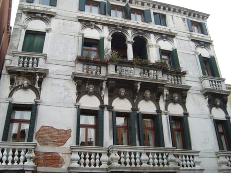 Venice, Italy, 02.22.2007. Venetian streets with graceful building facades. Grand Canal. Along the canal are Gothic and Renaissance palaces. Sights of Italy. Tourism business