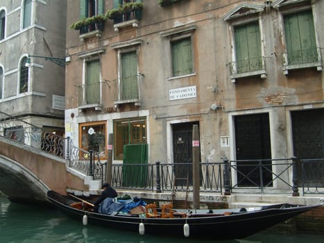 Venice, Italy, 02.22.2007. Venetian streets with graceful building facades. Grand Canal. Along the canal are Gothic and Renaissance palaces. Sights of Italy. Tourism business