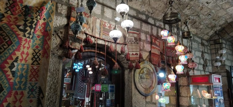 Traditional vintage Turkish lamps over light background in the night. Colored glass lamps and shades on the market in Sarajevo, Bosnia and Herzegovina. Sale of souvenirs in the market