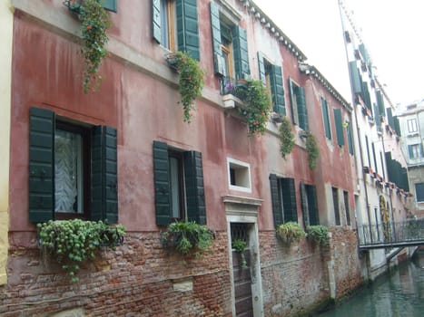 Venice, Italy, 02.22.2007. Venetian streets with graceful building facades. Grand Canal. Along the canal are Gothic and Renaissance palaces. Sights of Italy. Tourism business