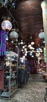 Traditional vintage Turkish lamps over light background in the night. Colored glass lamps and shades on the market in Sarajevo, Bosnia and Herzegovina. Sale of souvenirs in the market