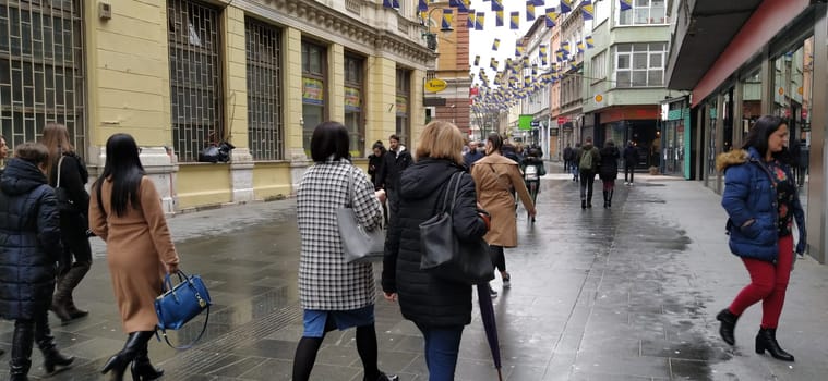 Sarajevo, Bosnia and Herzegovina, March 8, 2020. People on the streets of Sarajevo. Tourists and locals walk around the city center, visit shops, cafes. Historic Center of Sarajevo with Attractions.