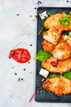 Grilled chicken breast or fillet on plate. Top view. Chicken breast in breadcrumbs