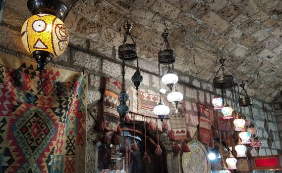 Sarajevo, Bosnia and Herzegovina, 8 March 2020, Traditional vintage Turkish lamps over light background in the night. Colored glass lamps and shades on the market.